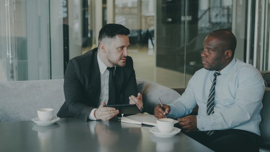 Visa consultant reviewing documents with client - First Travelling Step Consultants